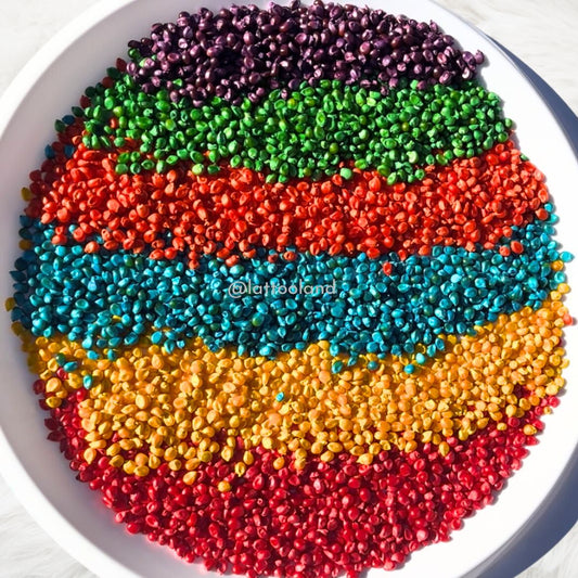 Child-safe, non-toxic colored corn kernels in a sensory bin setup, ideal for Montessori-friendly sensory activities and tactile exploration.