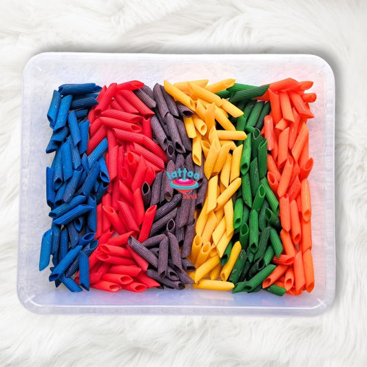 A vibrant assortment of multi-colored sensory pasta, showcasing a mix of bright reds, blues, yellows, and greens, perfect for creative play and educational activities for kids.