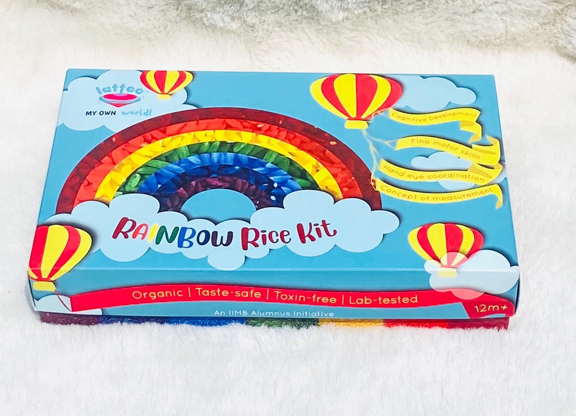 Sensory play kit box doubling as a sensory bin, featuring rice sensory toys and tools for calming sensory activities and measurement learning. Rainbow rice kit packaging box