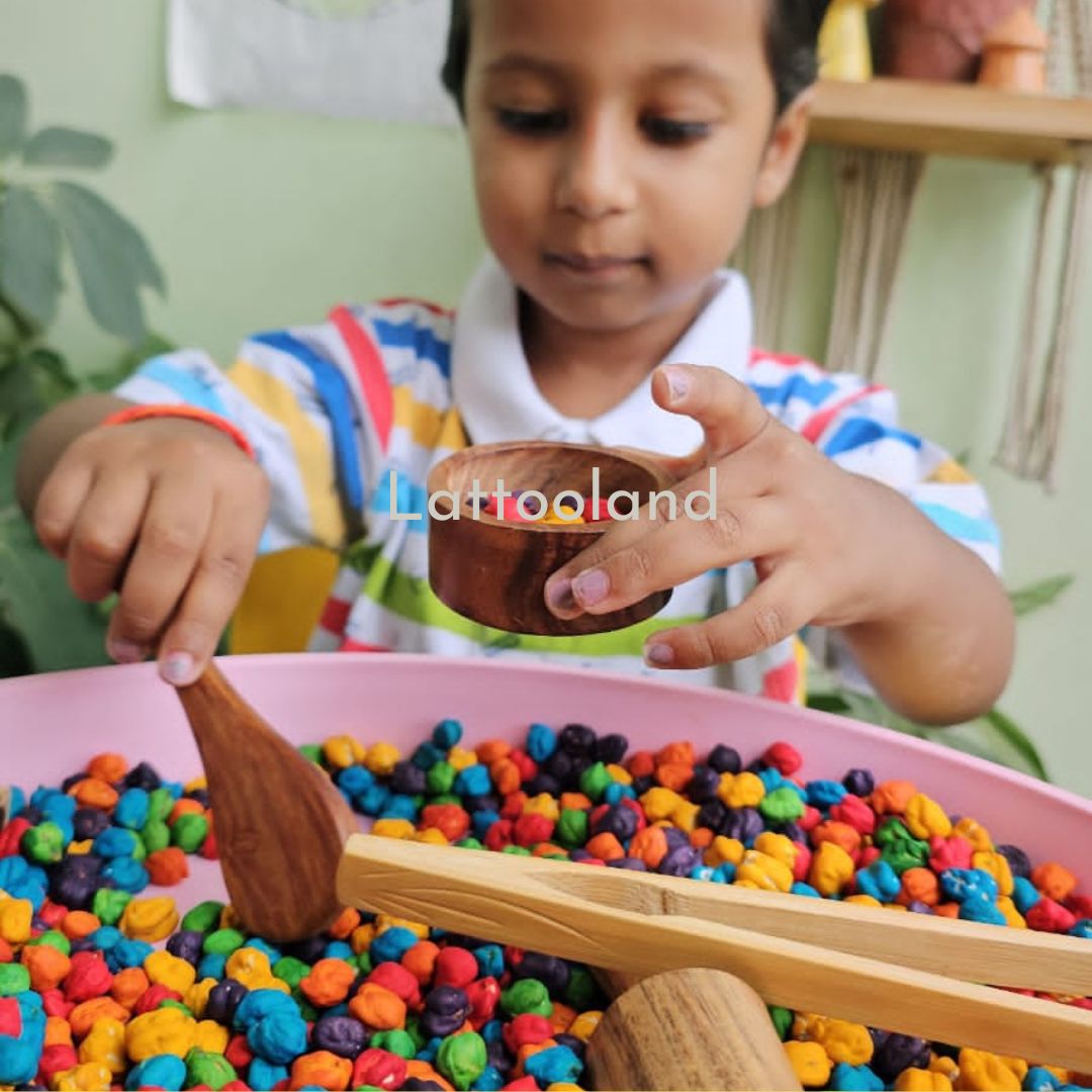 A Non-Toxic Sensory Chickpeas Kit featuring a set of brightly colored chickpeas in shades like red, blue, green, and yellow, packaged in separate compartments. The kit also includes small scoops, cups, and other tools for interactive sensory play, perfect for safe, hands-on exploration and learning