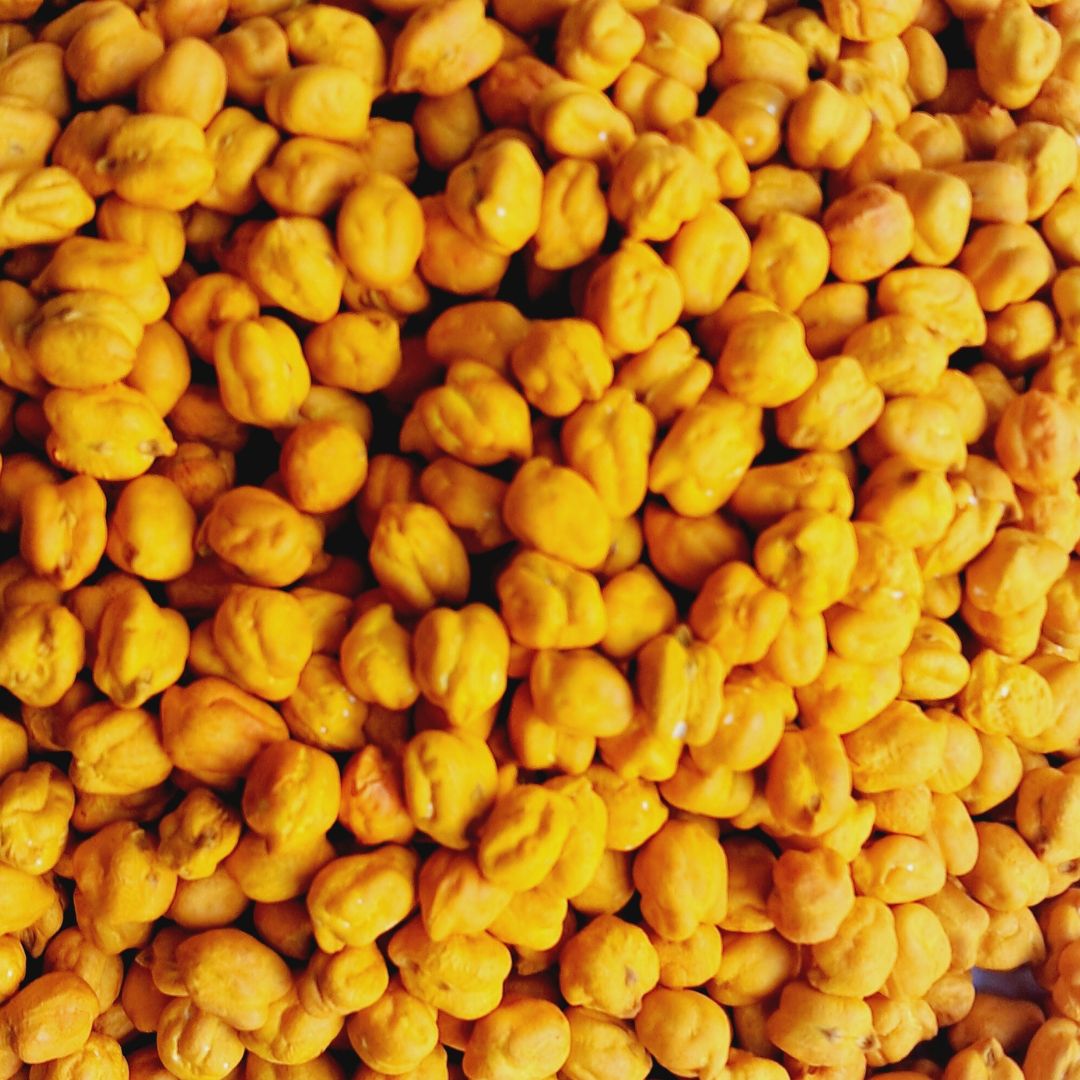 A Sensory Chickpeas Kit filled with vibrant yellow chickpeas, neatly packed in a container. The kit includes small scoops and cups for tactile play, offering a safe and engaging sensory experience with a cheerful monochromatic theme
