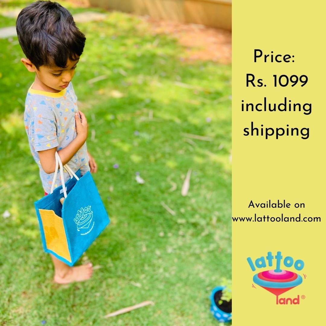 A small boy carrying gardening kit in a jute bag