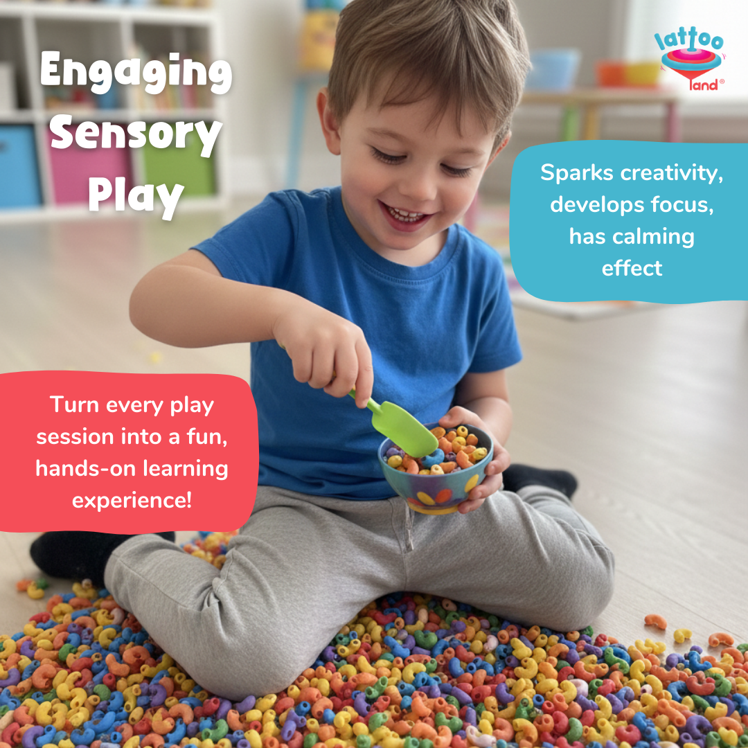A young boy sitting on a floor covered in colorful sensory pasta pieces, holding a small bowl and green scoop while engaging in a playful activity. 