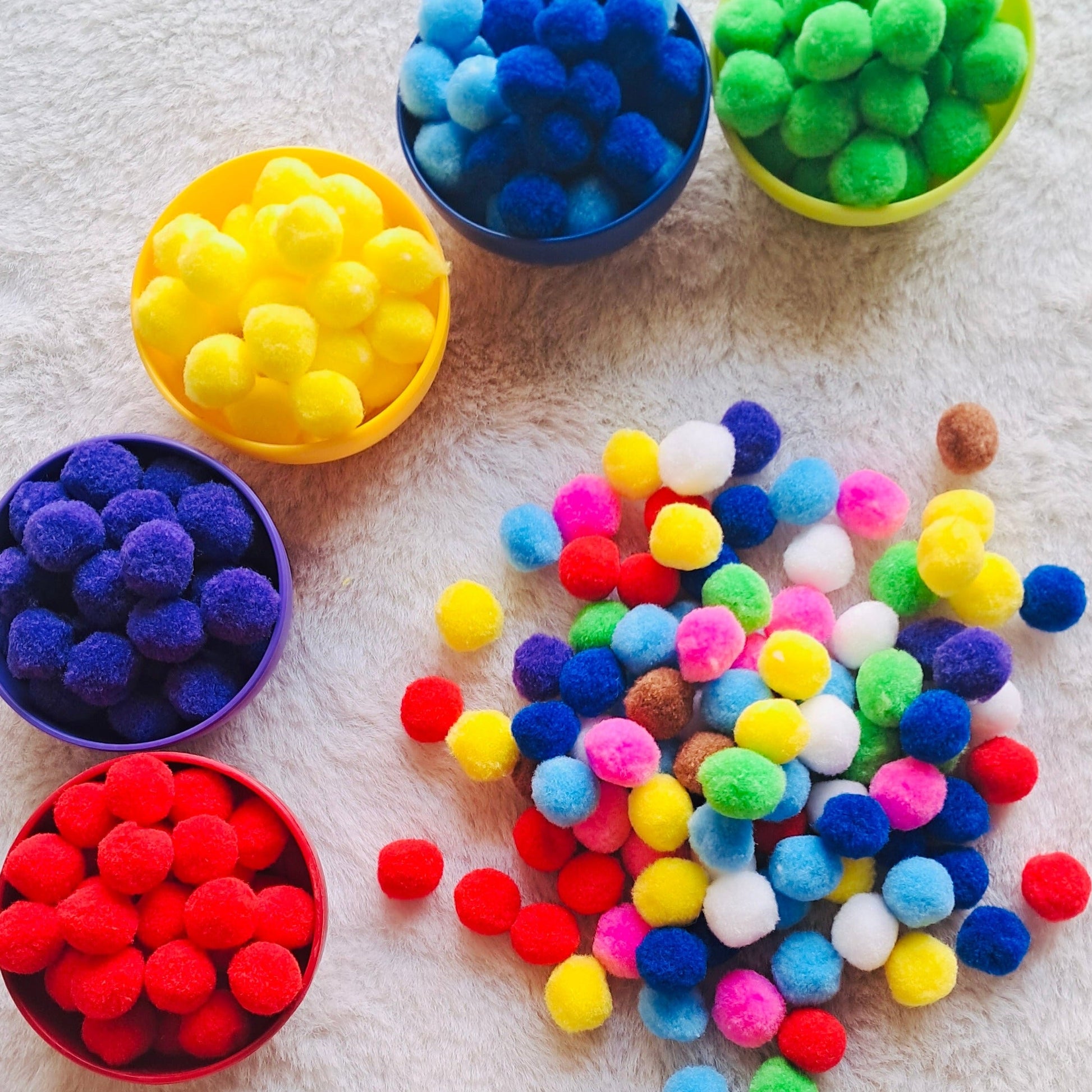 Close-up view of non-toxic, eco-friendly pompoms designed for sensory bins, motor skill development, and hands-on activities for toddlers and preschoolers.