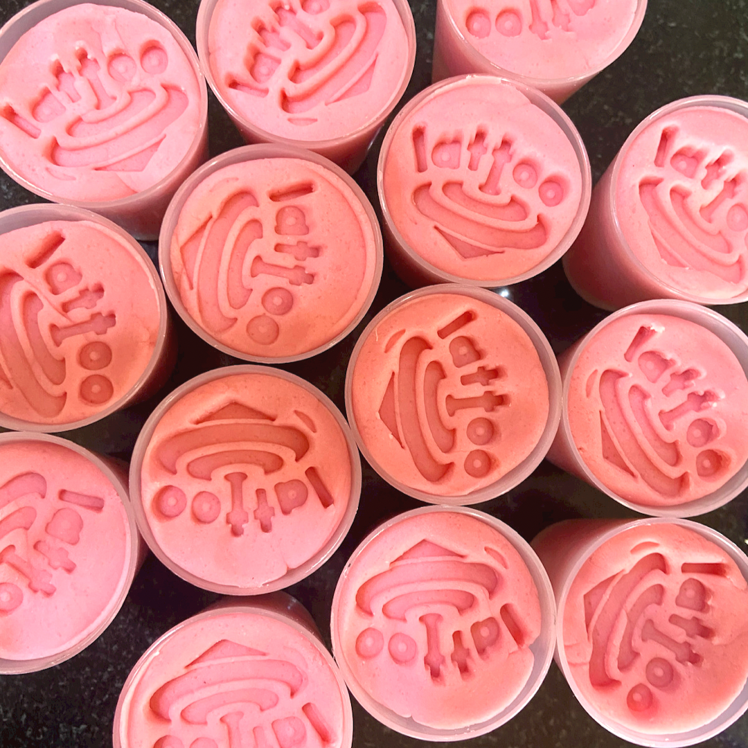 Soft baby pink-colored modeling dough, gently shaped into a smooth mound, offering a safe and fun sensory play experience for your baby.