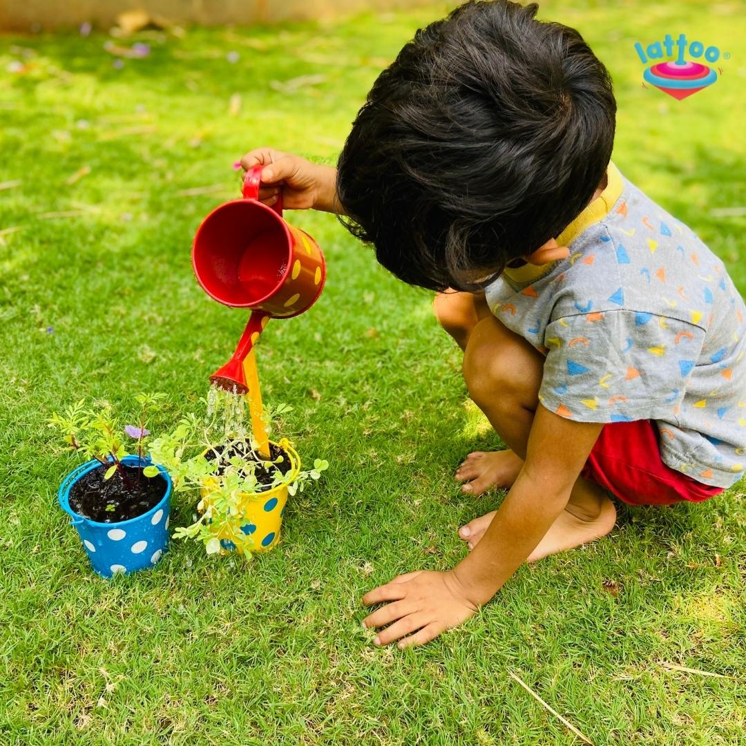 Boy watering the plant with premium quality water sprinkler garden tool.A set of beach and garden play essentials, including a bucket, shovel, and watering can—ideal for kids gardening, beach toys, outdoor play kits, and fun gardening kits for summer play.