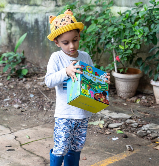 Children's garden set, including a metal watering can, trowel, and eco-friendly soil discs.