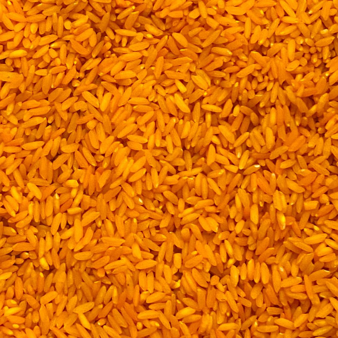 Close-up of orange sensory rice for toddler play and exploration